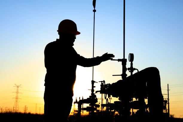 Silhouette Of Man Working in Oil Field